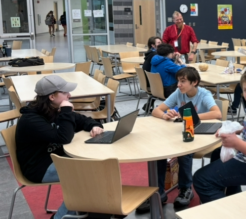 The Dungeons & Dragons Club at Sanford High School has been providing students with a creative and educational outlet for about five years, combining storytelling, critical thinking, and collaborative problem-solving in a structured, supervised environment.  The club meets Tuesdays and Fridays in the cafeteria immediately after school. All materials are provided, and no prior experience is necessary.  This year, the club is led by advisor Carrie Hathaway. "I wanted to make sure that these students got a chance to have the club because it is very important to them," Hathaway explains. Dungeons & Dragons is a tabletop role-playing game where students create characters and work together to navigate adventures guided by a student Dungeon Master. Far from the stereotypes some may remember, modern D&D emphasizes teamwork, creative thinking, and positive social interaction.  Students develop characters with unique backgrounds and abilities, then use strategy, negotiation, and problem-solving skills to overcome challenges presented in the story. The club has drawn about 30 students over the years, with a flexible, welcoming atmosphere that accommodates different participation levels. "I have a different and revolving crowd each time," notes Hathaway, emphasizing that newcomers can join at any point.  Students of all experience levels are welcome - they can jump right in and learn as they play, with experienced members providing guidance and support. The creative possibilities are endless. As one SHS student explained, the campaigns can vary dramatically: "It's still D&D, but some do pop culture in their campaign. Some just do normal medieval times." This means stories can incorporate sports, history, science, or any subject that captures students' imaginations.  Some campaigns even feature innovative twists as another SHS student explained: "you don't know what your character is... you start with a blank character sheet, and as you go on through the story, the master gives hints to what kind of character you want to play." Through these games, students practice communication skills in a low-pressure, supportive environment. They develop mathematical skills through game mechanics, enhance creative writing abilities through character development, and strengthen critical thinking through strategic decision-making. The game requires players to work together toward common goals.