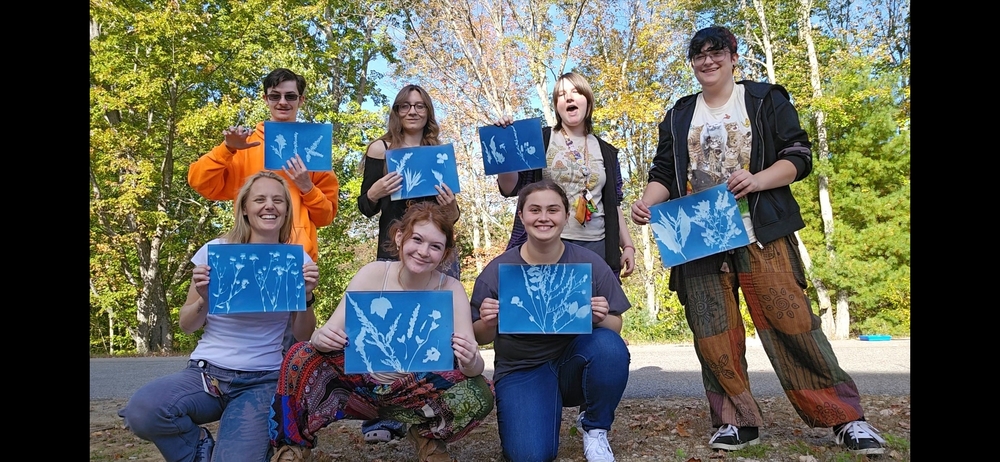 Every Thursday afternoon, a group of Sanford High School students gather with sketchbooks in hand to slow down, step outside, and connect with the natural world around them. Welcome to the Nature Journal Club offered at the high school. The club was started two years ago by wildlife biology teacher Lindsay Strout, who noticed that a handful of her students had a genuine hunger for nature observation that extended beyond the classroom. She wanted to give students an outlet that wasn't sports, theater, or traditional art club. "There's got to be somewhere, something else for them," she said. This year, the club has seen its largest group yet, with students ranging from freshmen to seniors. On any given Thursday, you might find students sketching insects, pressing leaves onto light-sensitive paper to create cyanotype prints, carving rubber stamps, or following the trail behind Sanford High School to check on local beaver activity along the river. In the fall and spring, the group ventures outside to explore the school's trails, catch frogs near the vernal pool, or simply sit quietly and observe. Nature journaling is less about artistic skill and more about observation and recording. "It's not about the pretty pictures," Lindsay explains. "It's more about connecting with nature, observing, and recording."  Students are encouraged to write down what they see and what catches their eye, with no required format and no wrong answers. Lindsay brings that same passion to her own practice, regularly connecting with a wider nature journaling community and attending conferences to deepen her craft. SHS student Esther Bronwyn spoke to the sense of community Strout has built. "Her room is awesome, all the things that she's made and collected are fun to look at," she said. "It's really cool that she brings kids in." Students also help shape what happens in the club. When one student came in working on a rubber block printing project, Lindsay immediately invited them to teach the technique to the whole group. No one is told what to draw or how to draw it, and students can even create their own handmade journals, giving each member a sense of ownership over their work. The club is open to any Sanford High School student and meets every Thursday after school. No prior art experience or science background is required, just curiosity and a willingness to spend some time outside. Fellow club member Emma Cormier put it simply: "This is a club that I really adore. I'm probably going to come back as long as Ms. Strout continues the club."