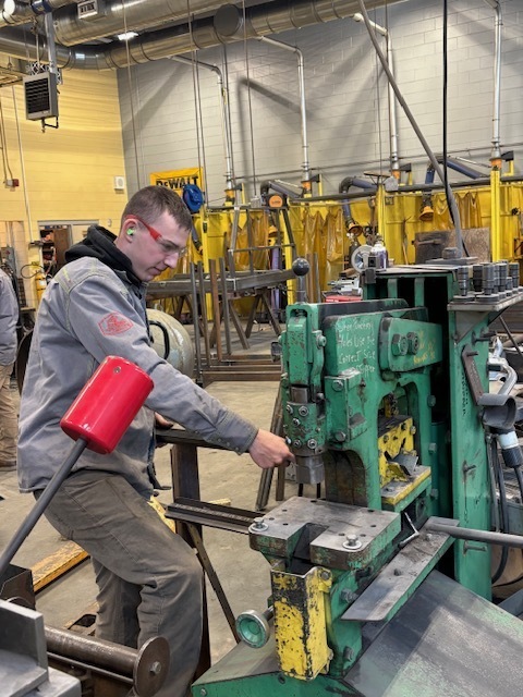When Anderson White, Spencer Jourdain, and Duncan Blanchard walk into Rubb USA in Sanford, they're not just students anymore. They're welders, fabricators, and professionals learning their trade alongside seasoned workers. For these three Sanford Regional Technical Center students, the transition from classroom to factory floor has been about more than earning a paycheck. It's been about discovering what they're capable of. White was the first to make the leap, landing his position at Rubb last spring after interviews with Nate Bedell, Derek Gauvreau, and Eric Glidden. By June, he was spending his summer fabricating legs and roofs for the metal buildings the company manufactures. Jourdain and Blanchard followed about a month and a half ago, joining their classmate from Adam Hartford's welding program on the factory floor. "It definitely helped a lot," Jourdain said about having familiar faces around. "I think the first couple days I was really nervous, but Anderson was there helping me out. And everyone at Rubb was wicked nice and always showing you what to do." The three students work Monday through Wednesday, though their schedules vary. Blanchard, a senior at RSU 21 with senior release privileges, can arrive as early as 7 a.m., while Jourdain and White, both Sanford High School students, typically start after their morning classes. Their days alternate between cutting tubing in the saw shop, drilling ventilation holes, jigging pieces together, or spending full days welding. For Blanchard, the learning curve has been steep but rewarding. "Come the first year, I already knew about half the stuff I do right now," he said. "Between Adam Hartford and Rubb, I've learned a tremendous amount of things that I will definitely be using in the future." White's journey required strategic planning from his freshman year to complete two full SRTC programsāprecision manufacturing and welding. "I knocked out a lot of credits. I was able to do two of my math credits and two of my English credits, including the extra one that I needed outside of the core," he explained. Perhaps most valuable are the life lessons the students are absorbing. Blanchard recalls advice from a coworker: "There's no such thing as a mistake if it does not leave the doors." The philosophy has helped him, who admits to being hard on himself. "I'm a pretty harsh guy on myself for making mistakes. But then I kind of realize everyone does it." Jourdain has learned about continuous growth. "Anyone can weld, but not everyone can read the blueprints," he said. "As long as you never stop learning, you'll always be growing." Derek Gauvreau, Rubb's director of manufacturing, has been impressed with what the students bring to the job. "It has been a distinct pleasure to work with these young men and see them so excited to learn about the work we do here at Rubb," Gauvreau said. "They arrived with a strong work ethic and a clear desire to understand every aspect of our building systems. It is refreshing to see that kind of drive, and we are proud to have them on the team." The students credit Hartford, who brings 15-20 years of welding experience and a background as a diesel mechanic, for preparing them. "He's always showing people how to do things differently and overcome hard obstacles," Jourdain said. Hartford has been working to build a partnership with Rubb for several years. "Rubb Building Solutions has been amazing to work with for student internships," Hartford said. "A few years ago, we started working with them to get kids there to start into a career, and they have set the standard for what we hope all our internships look like. Derek Gauvreau and Nate Bedell are really great with the students who intern with them. They are welcoming and understanding that the students are learning and help them gain knowledge, skills, and confidence in their shop setting." As they look toward graduation, the three see different paths forward. Blanchard plans to join the Army to gain additional skills before returning to welding. "It's one of the best things that's ever happened to me in my work life," he said. "I absolutely love it there." Jourdain wants to stay at Rubb for several years before eventually opening his own business doing rust repair and light fabrication. White plans to continue building his career at Rubb, where the company has been supportive of young workers finding their way.