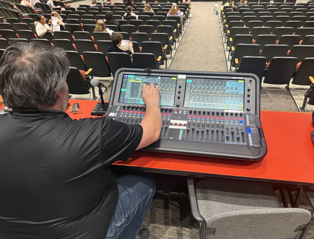 The Sanford High School Performing Arts Center has a new Allen & Heath digital mixing console, thanks to a generous gift from the Gerard and Gertrude Genest Charitable Trust, and the upgrade is already making a difference for students, staff, and audiences alike. The foundation reached out to the school, asking simply what was needed. Brett Williams, Director of the Sanford Performing Arts Center, said the answer came down to sound. The center had been working with a soundboard installed when the building opened in 2018, one that wasn't quite built for the scale of programming the center has grown into. "Most high school Performing Arts Centers don't really take the room out for a ride the way we do," Williams said. "We're bringing in national tours, doing the Newsies mix with 25 wireless microphones plus 15 inputs for the orchestra, and bringing in tribute acts and big bands that require a really great live mix. We weren't able to provide that." The gift addressed two needs at once. The center's outgoing Soundcraft board was repurposed for the cafetorium at Sanford Middle School, which already had quality ceiling speakers but no way to connect a microphone to them. Pro AV completed the full installation over April vacation, giving the middle school a functioning audio system for the first time. "This will be a big help for presentations, small assemblies, faculty meetings, parent nights, the talent show, theatre company, and so much more," said Sanford Middle School Principal Joe Mastraccio. "We kind of hit two targets with one shot," Williams said. "This gift allowed us to fix the deficiencies at the Sanford Middle School Cafeteria at the same time that we're fixing the deficiency with the soundboard at the Performing Arts Center. It was exactly what we needed." Williams said the new board is the right tool for the job. he said. "This Allen & Heath board is appropriate for what we need, and it does it with excellence. It's what we need to continue the quality of programming that we're bringing here." The board arrived just two weeks before Newsies opened, so the school brought in a sound engineer already familiar with the Allen & Heath model, to train students and staff before opening night. Williams called the experience a learning curve worth climbing. "It really brings us up to where we should be with our capabilities with mixing sound,” he said. For Williams, the gift reflects something larger than a single piece of equipment. The Genest family has remained a consistent presence at the Performing Arts Center and continues to check in on what the school needs next. "When they reach out to say, 'What do you need now? What's the next step for the Performing Arts Center?' It means a lot to have neighbors and community who understand what we're doing here," Williams said. "We're really grateful for their generosity."