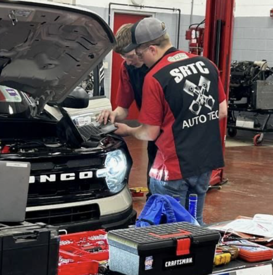 Throughout the school year, local business owners, managers, and industry professionals walk through the doors at Sanford Regional Technical Center—not as customers or inspectors, but as partners in education. They sit down with instructors, tour classrooms, and sometimes even meet with students. They're members of SRTC's program advisory committees, and they're helping shape what students learn. Every program at SRTC has one of these committees. SRTC Director Matt Petermann explains that they "provide us with relevant information about what happens in that particular industry in regards to technology, equipment, and workforce demands. Without these positive connections to our community and industry, our students would leave us and be at a disadvantage. These committees help keep our programs relevant and ensure that our students are receiving the best education they can get." The meetings focus on practical matters. Rich Couture, SRTC's Automotive Technology instructor, describes the committees as building "a strong connection with local business owners, managers, hiring personnel as well as parents of current and former students." These meetings create transparency about what's happening in the classroom—from the specific skills being taught to the operating budgets and the technology students are using. When industries change, the committees help instructors adjust. "It helps us shape our classes for new technologies and equipment being used so that we can stay current with what is trending now in our respective industries," Couture explains. Sometimes these conversations lead to concrete solutions. Brett Staples, Service Manager at Marc Motors in Sanford and a member of the Automotive program's advisory committee, notes that the advisory gives businesses a chance to "find out if any tools or equipment are needed in order to efficiently teach these students." When committees identify gaps, they can help programs secure what they need to keep up with industry standards. The student benefits go beyond updated curriculum. Couture sometimes invites students to attend advisory committee meetings. "On more than one occasion, I've had students leave the meeting with job interviews lined up," he shares. It's a direct pipeline from classroom to career. "Employers are realizing that to build their business with strong employees, SRTC may be a good option to find fresh new and upcoming talent," Couture says. For Staples, the commitment is straightforward: "These students are the future of our business. Without the younger people coming into the trade, there wouldn't be anyone to replace the seasoned techs as they retire."