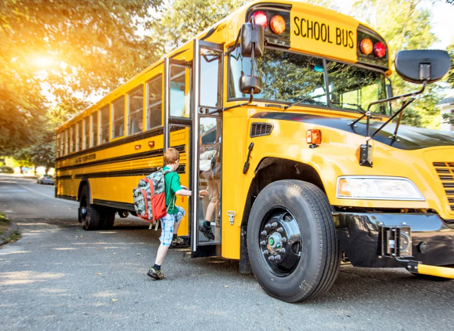 Child getting on bus