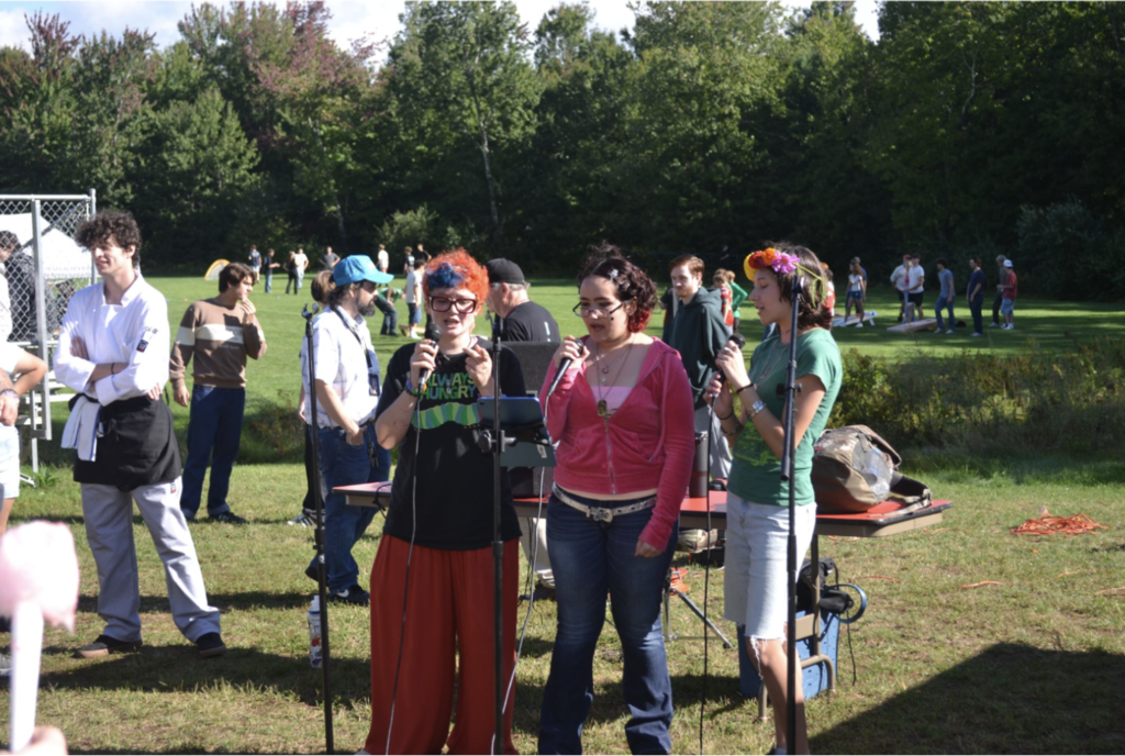 Three students sing together.