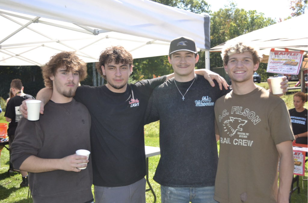 Four boys pose for a picture together.