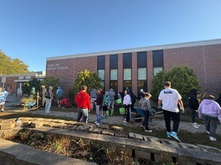 Students and staff work outside of Sanford Middle School's campus.