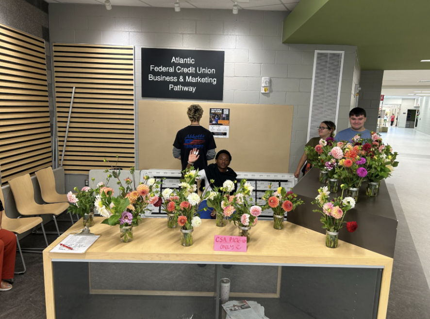 Four students sell floral arrangements for the CSA project.