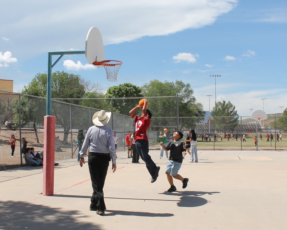 students playing basketball with teacher during Map Celebration