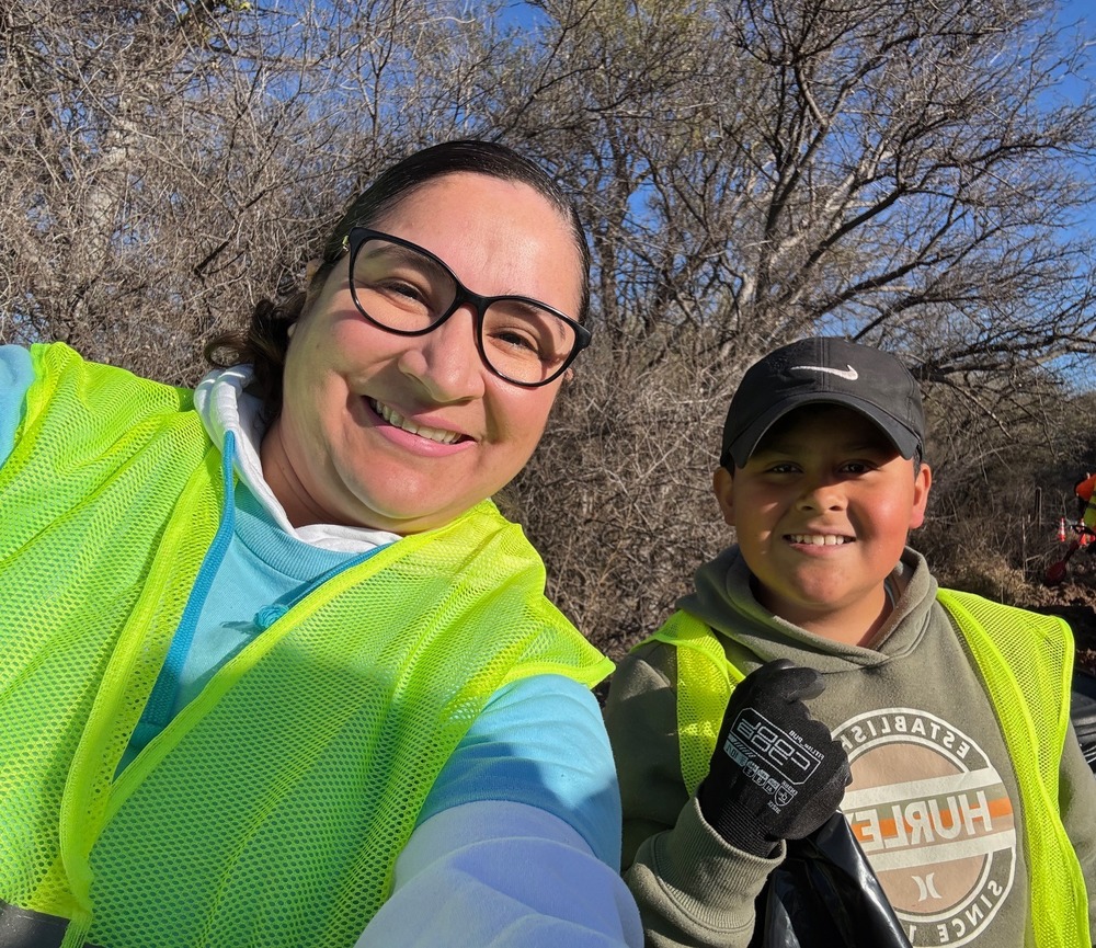 student and club advisor  smiling and posing during clean up at SC River with FBLA