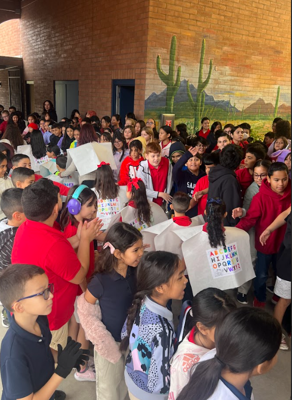 Older students cheering on the kindergarteners