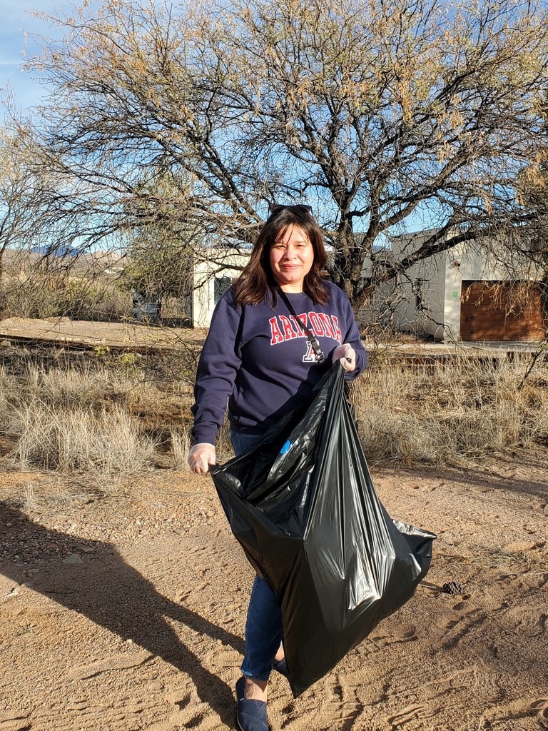 Mrs. Roxie Leyva cleaning up walking path.