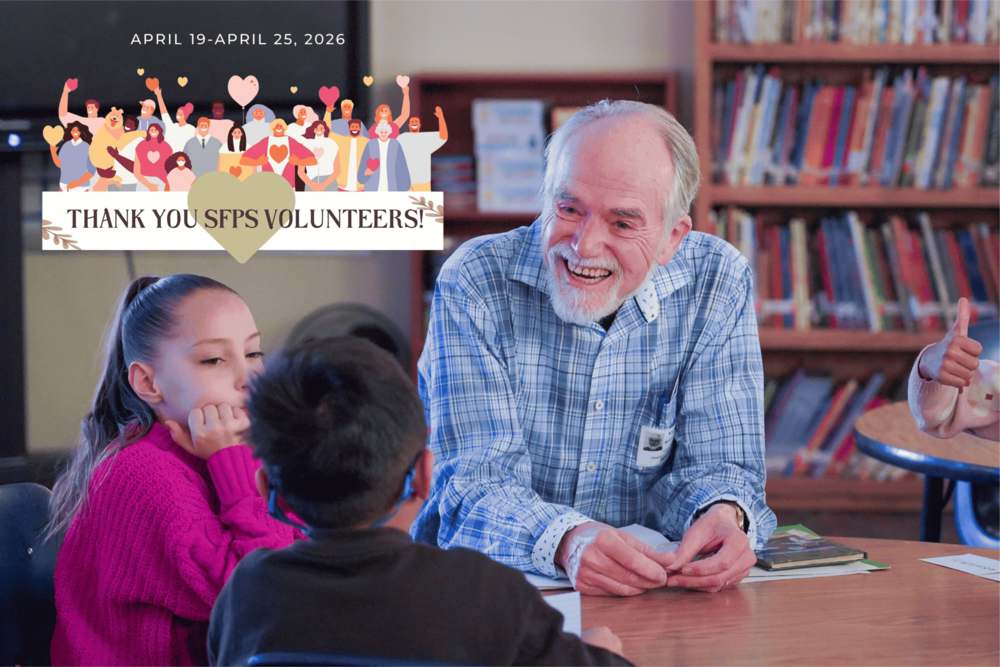 a volunteer works with students