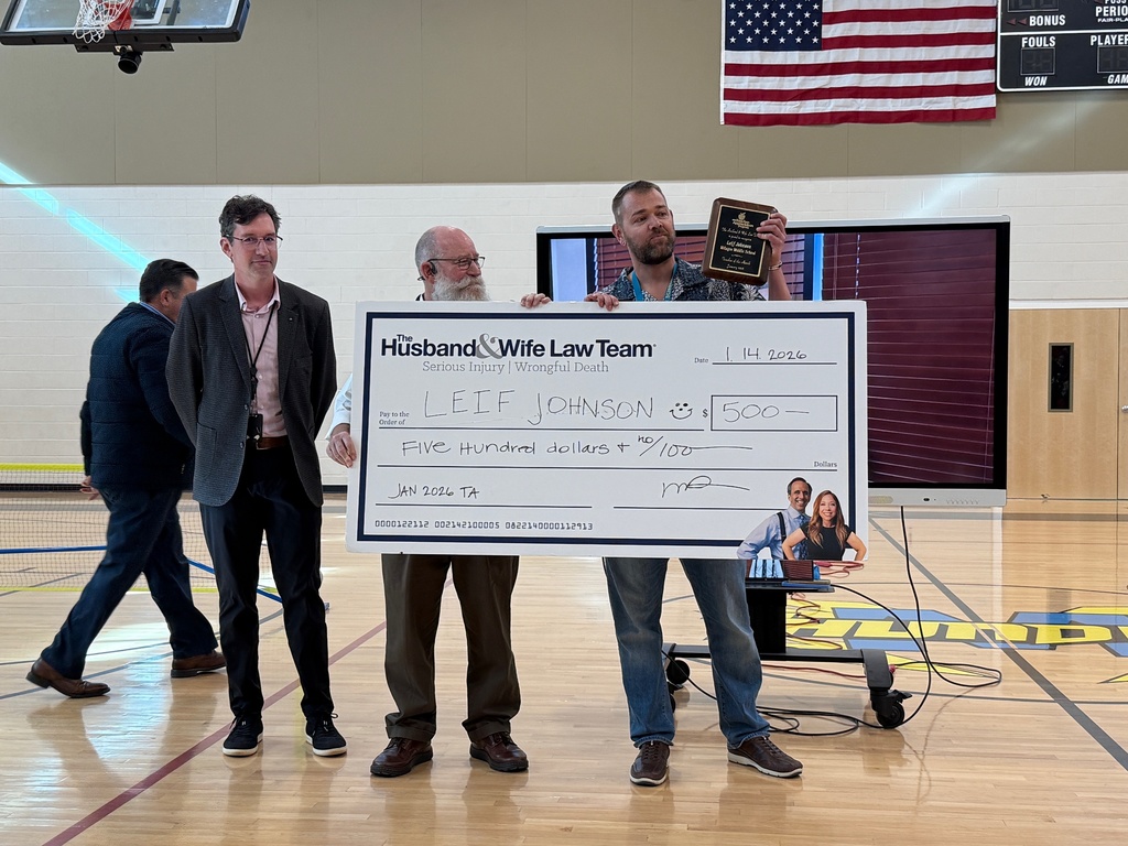 Husband and Wife Law Team present a 500 dollar check.