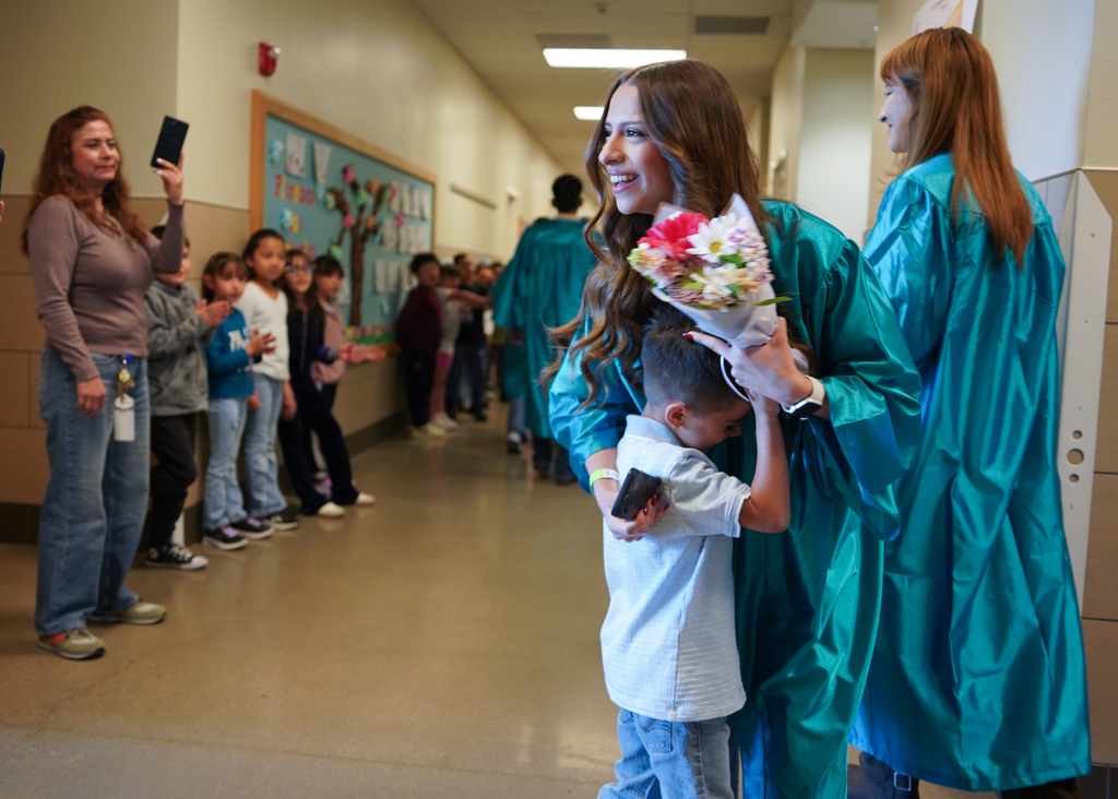 A child hugs his sister during CHS Senior Parade.