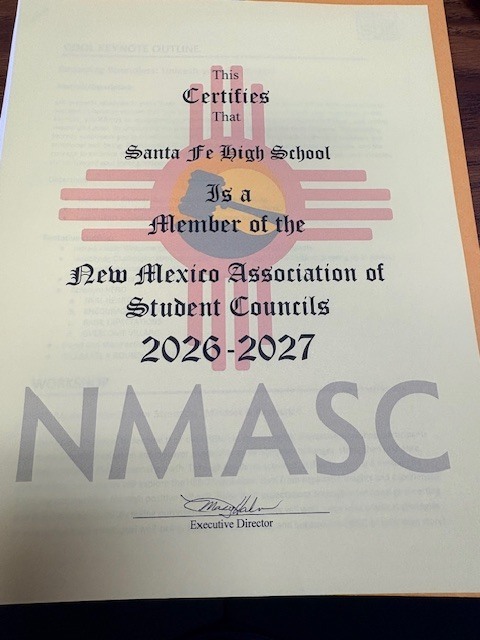 A certificate on a table displays membership for the New Mexico Association of Student Councils.