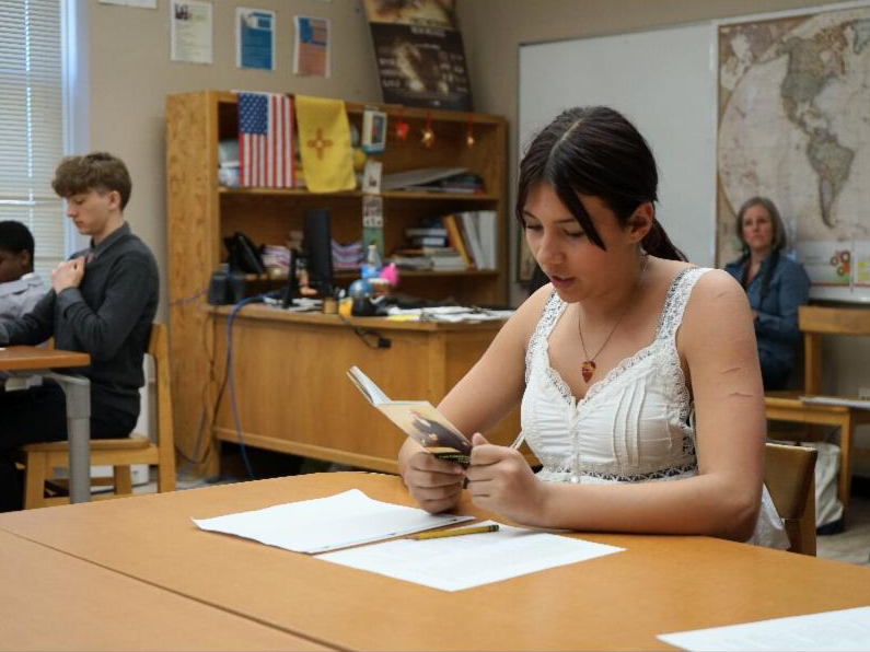 Izabelle Steelman, a 7th grader at Mandela, reads the 6th Amendment aloud to the class during Thomson's visit. 