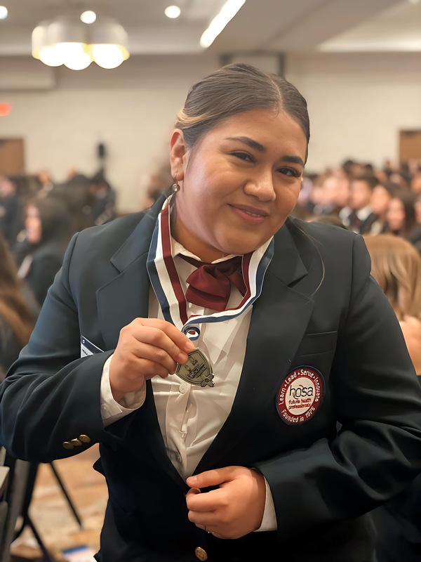 Melanie Sosa, a sophomore at CHS, displays her medal proudly. 