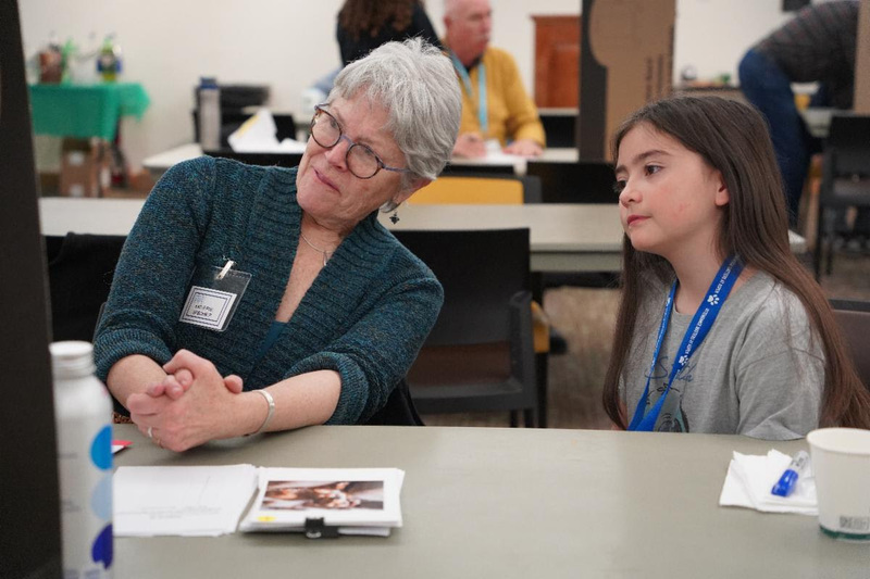 volunteer works with student