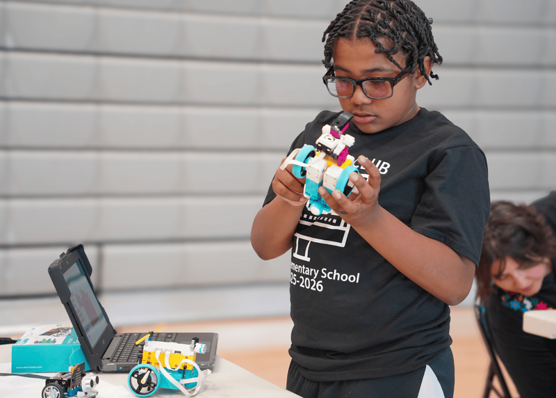 Pinon student works on a robot.