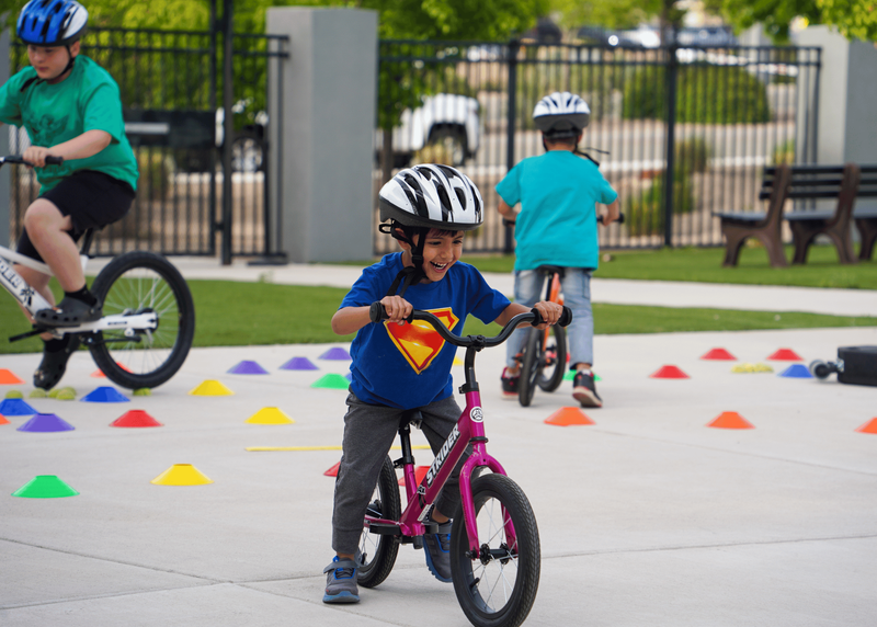 A child rides a bike during the SFPS Bike Rodeo Clinic, where children learn the skills and safety precautions needed for safe cycling.