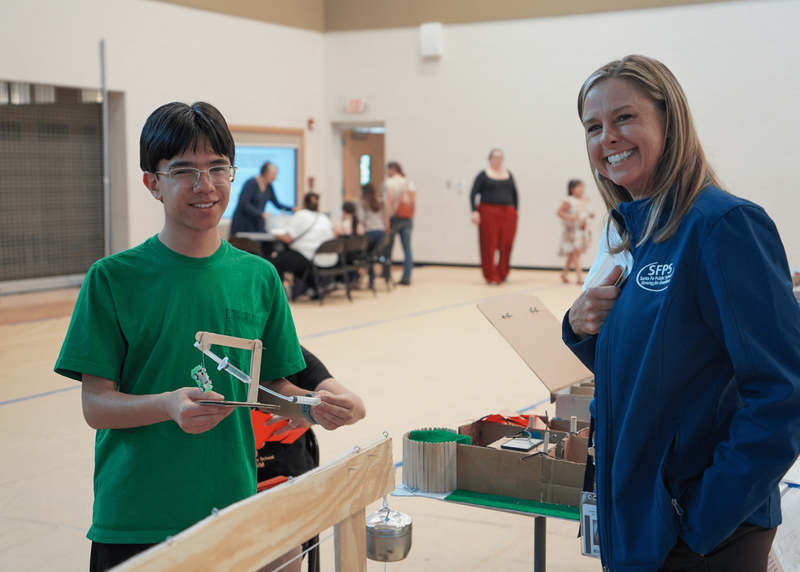 A student from El Dorado shows his science project to Superintendent Dr. Christine Griffin