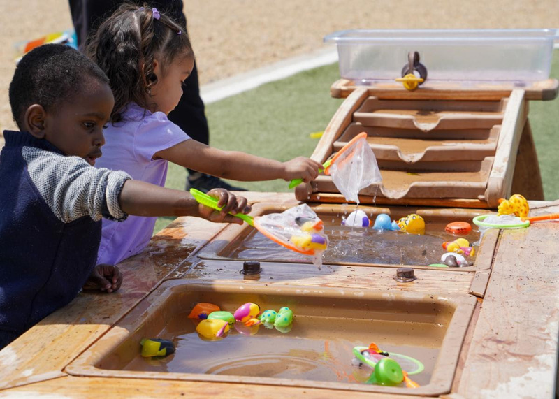 Children practice their motor skills by fishing for rubber ducks during the SFPS Annual Literacy Carnival.