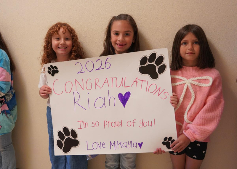 Third graders from Ramirez Thomas Elementary cheer on the Capital High graduates during the parade on Wednesday morning.