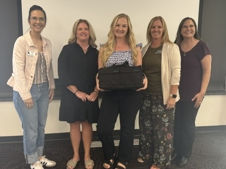Parent Educator, Holly Gordillo receiving the Plusoptix Vision Screener