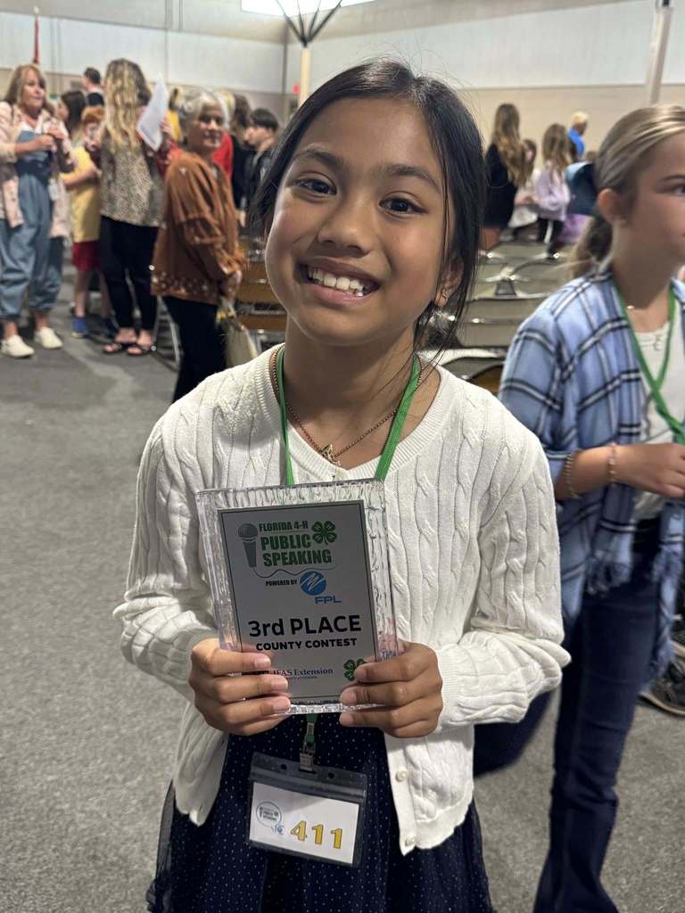 Mikaela smiling with her 3rd place plaque.