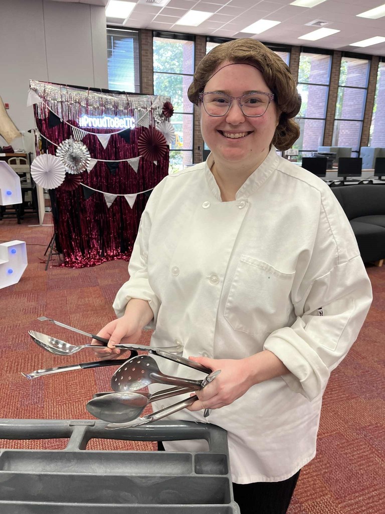 Culinary student with serving utensils