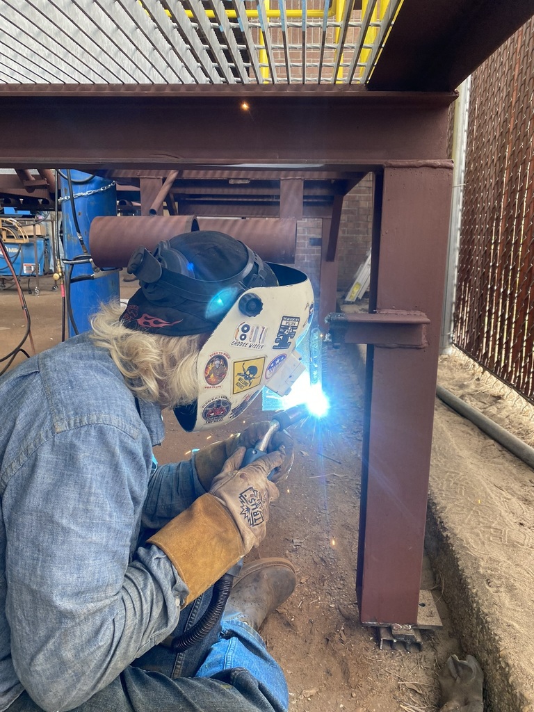 Welding Training Platform Project Assembly- Student Welding Under the Platform