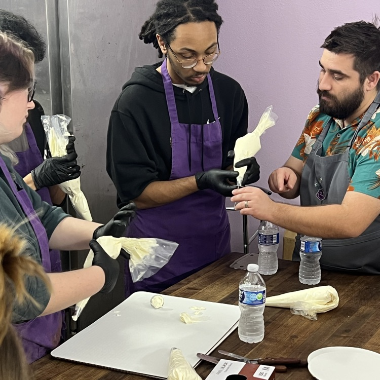 students learning to pipe icing 