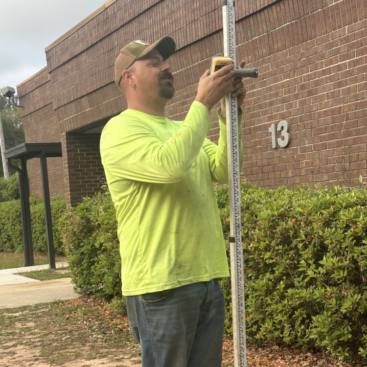 student with survey equipment 