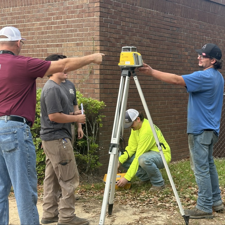 more students with survey equipment 