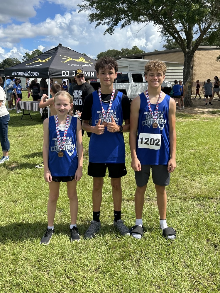 Three East Bay Cross Country runners display their medals after competing at the Pace Patriot Invitational. Congratulations to Weston G., Matthew F., and Ayla G.