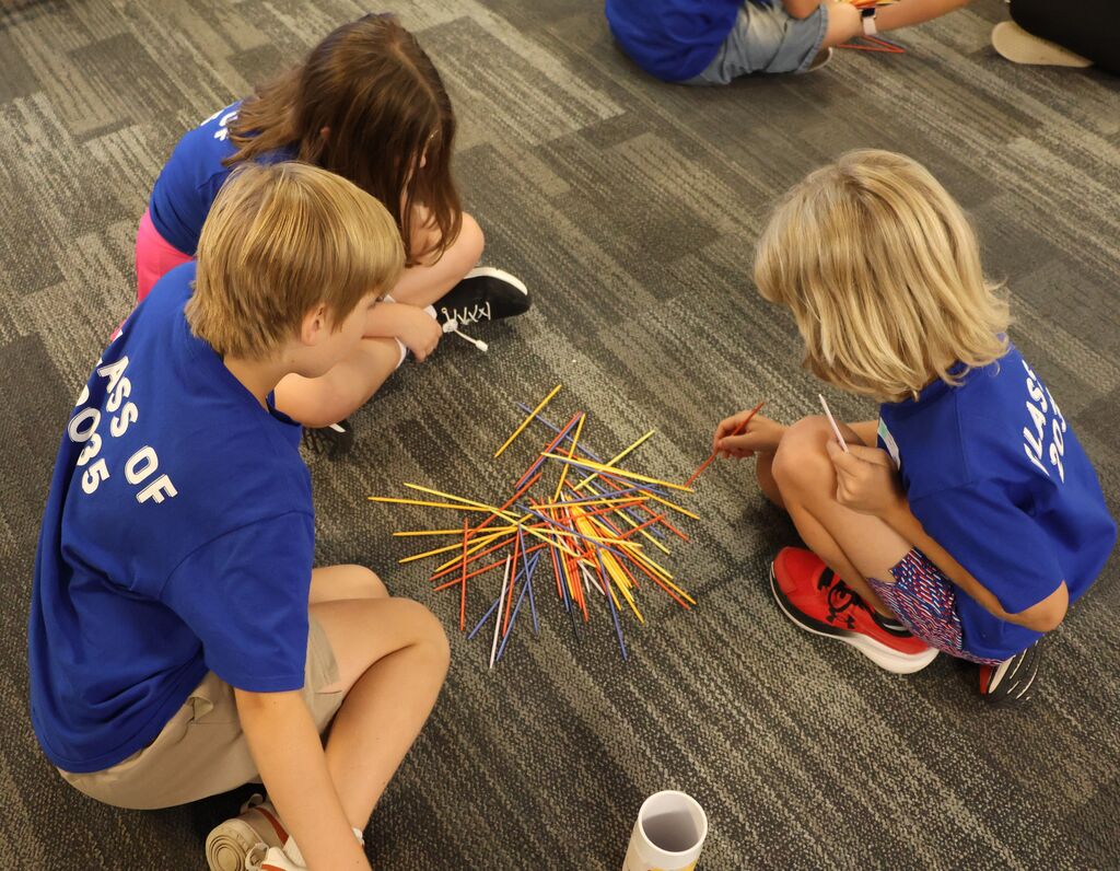 Kids playing pick up sticks