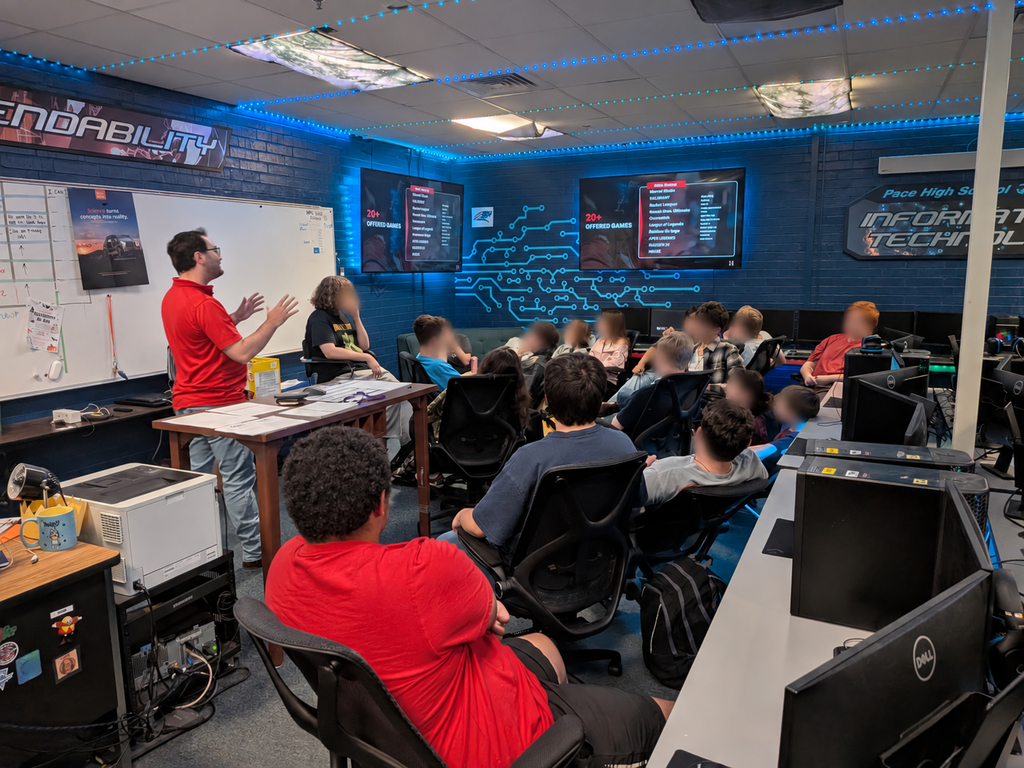 Image Pace High School esports athletes listening to Ryan Doyle, Director of Huntingdon College esports program