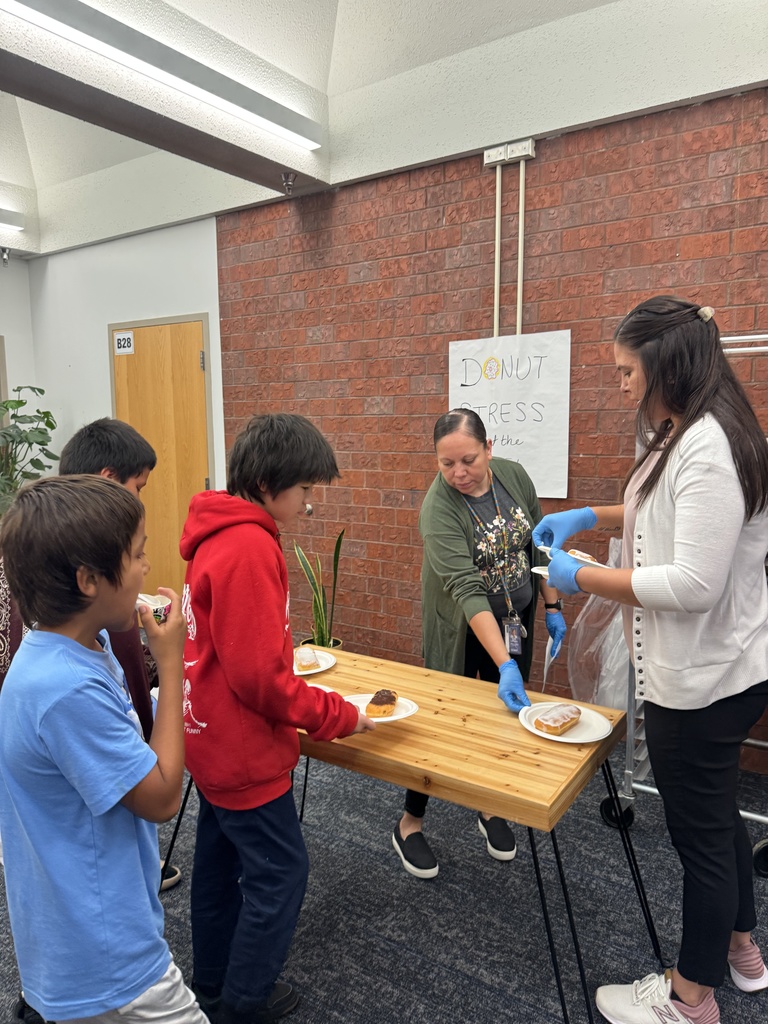 Students picking up donuts from principals to celebrate the first day of Fall benchmark testing.