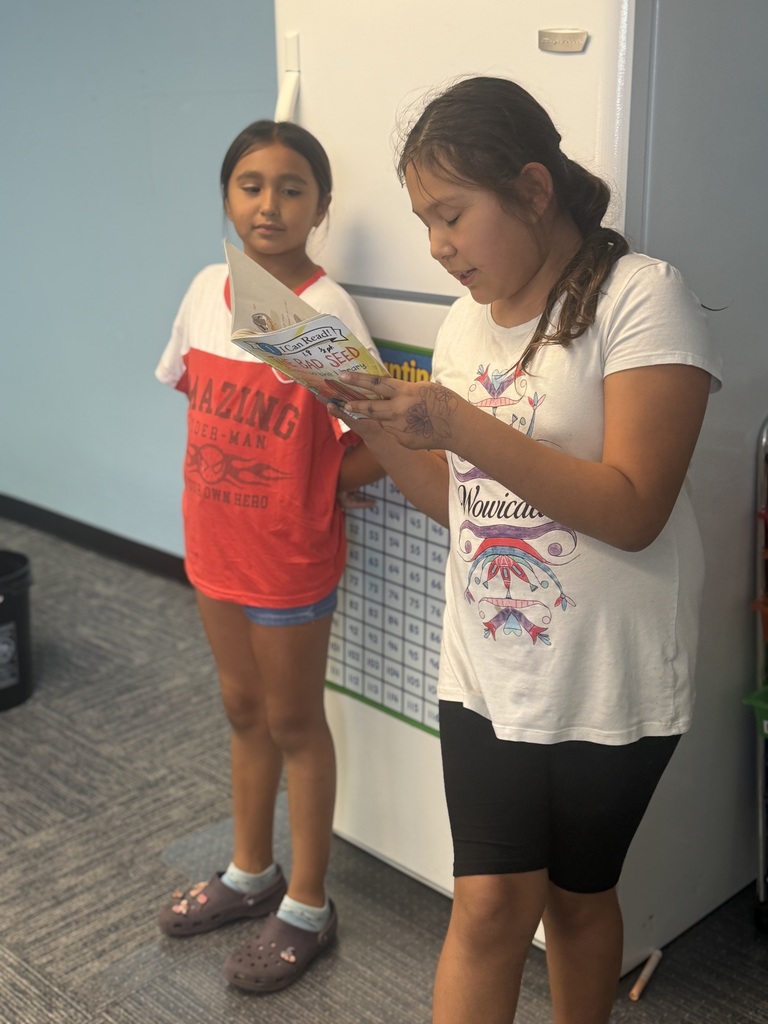 Two afterschool program students doing a read-aloud.