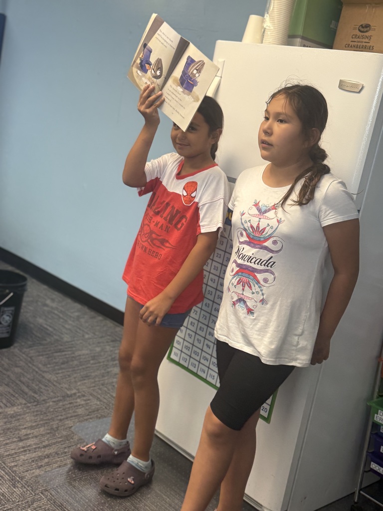 Two afterschool program students doing a read-aloud.