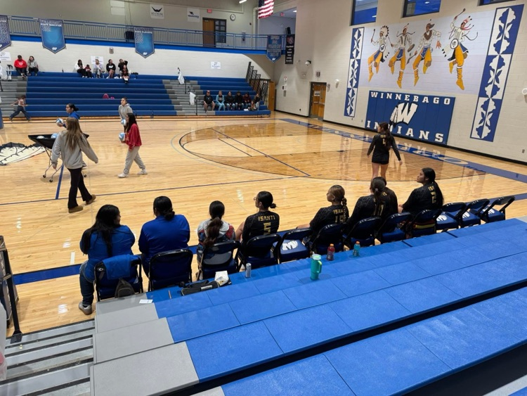 pictures of the Isanti Volleyball team sitting on a bench
