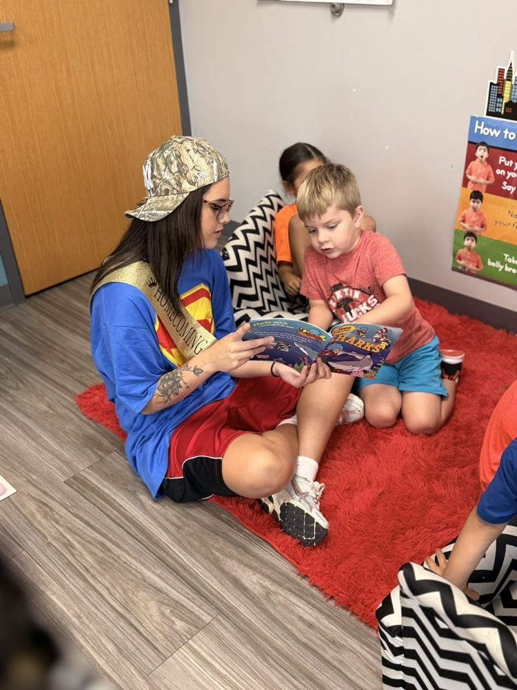 picture of volleyball players reading to our headstart students