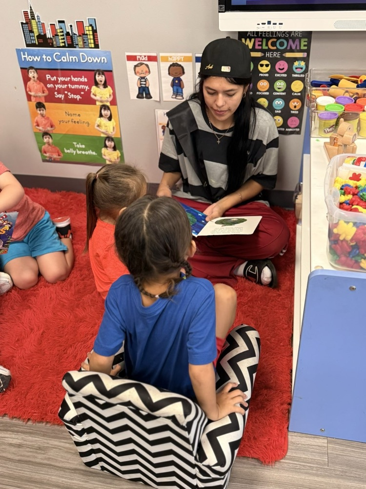 picture of volleyball players reading to our headstart students