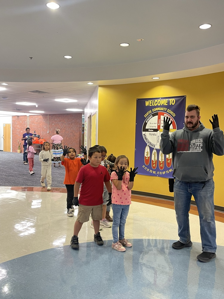 image of students with gloves on to pick up trash