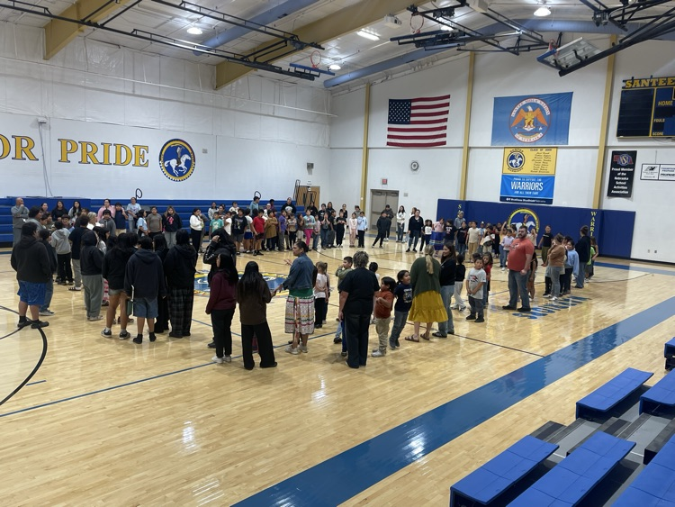 group picture of our students standing in a circle for the grand entry