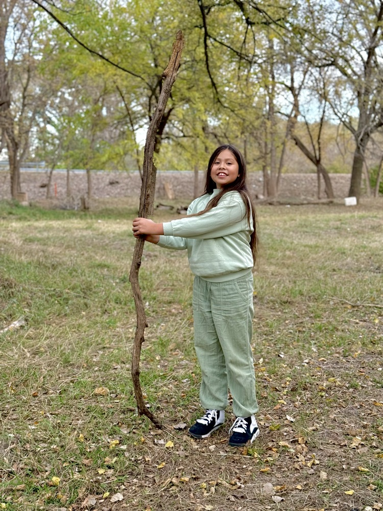 student standing with walking stick
