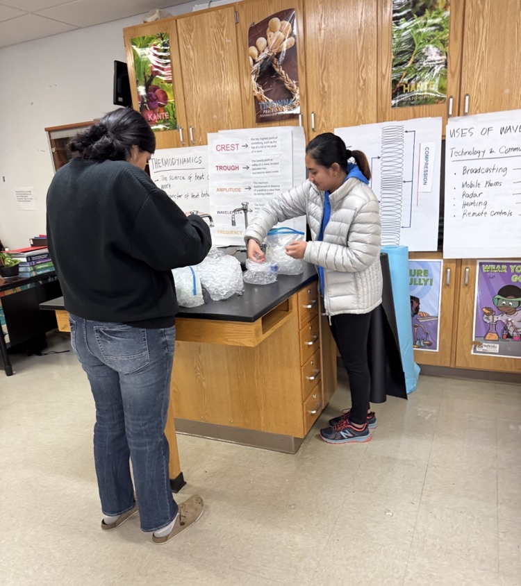 picture of 2 students mixing ingredients to make ice cream