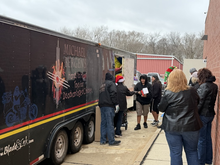 picture of a trailer full of toys of a group giving kids toys 