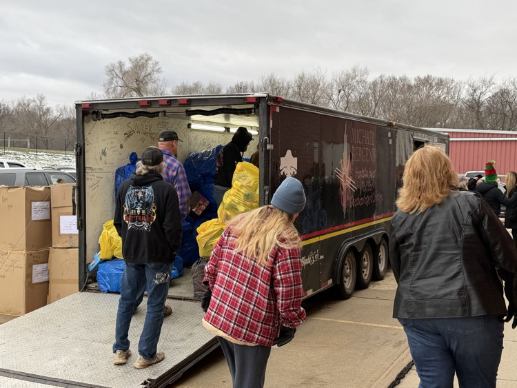 picture of people unloading toys for students 