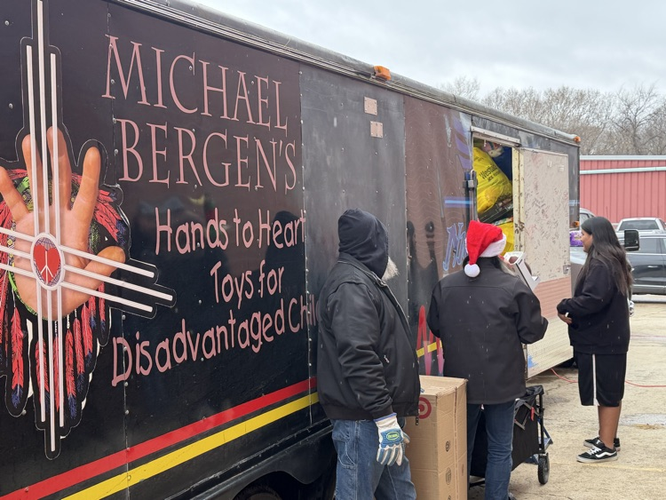 picture of a trailer and the team handing out toys