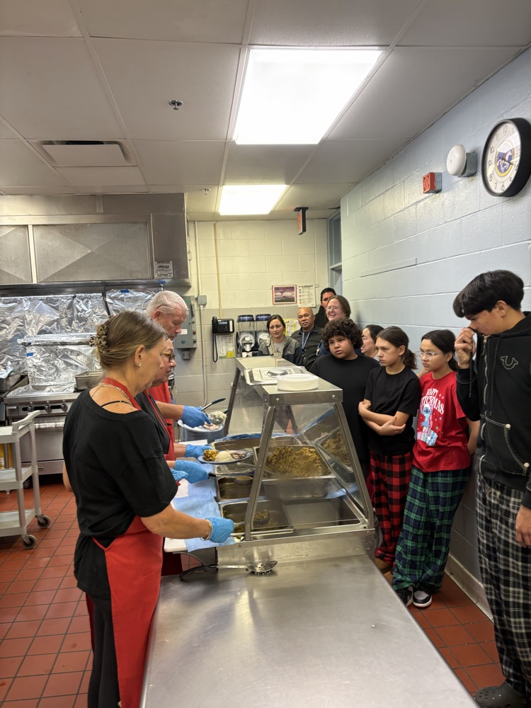 picture of staff members serving lunch 